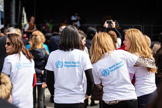 Group of women wearing white T-shirts with WHO logo